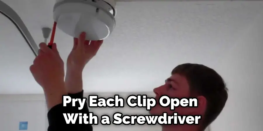 Pry Each Clip Open With a Screwdriver