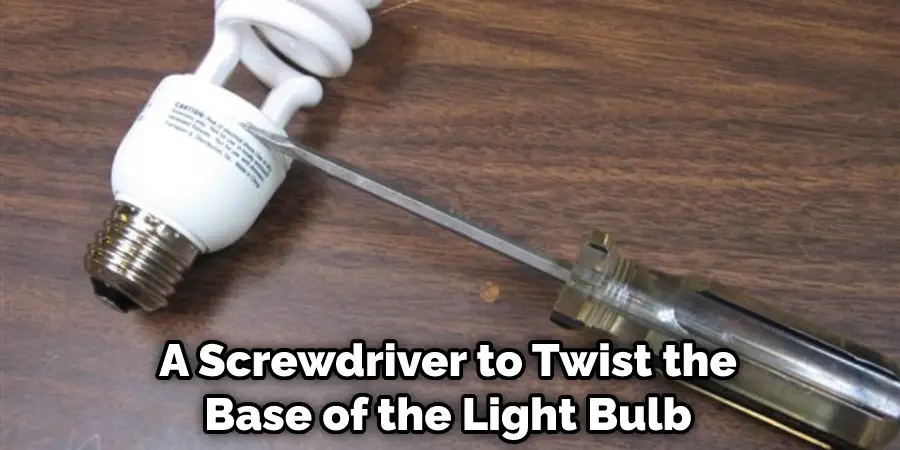 A Screwdriver to Twist the Base of the Light Bulb