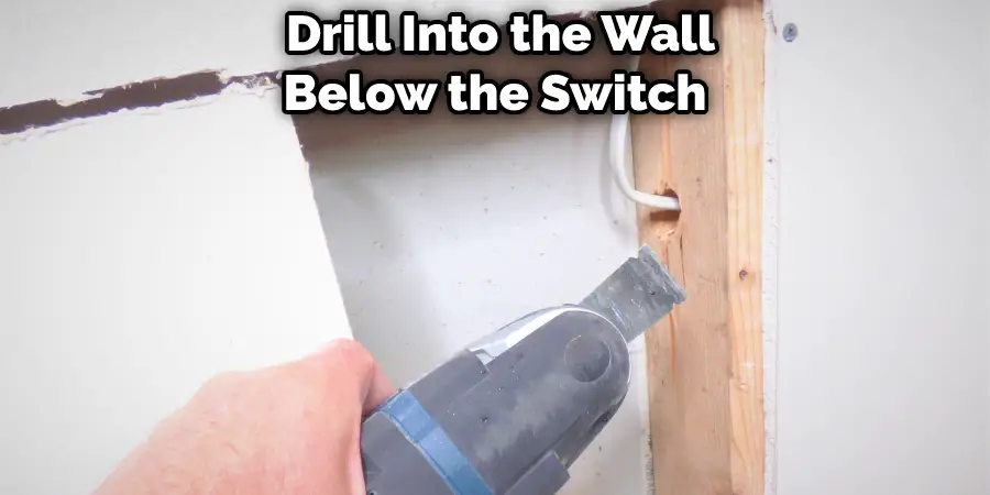  Drill Into the Wall Below the Switch