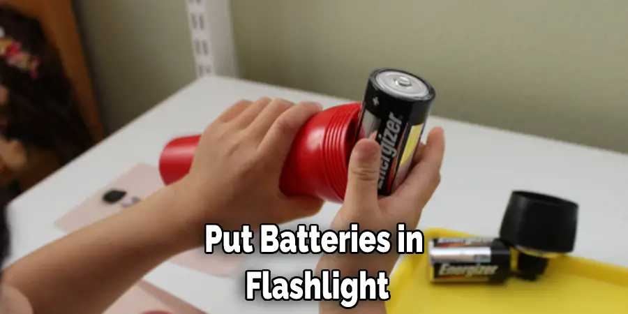 Put Batteries in  Flashlight