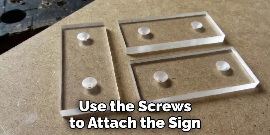 Use the Screws to Attach the Sign