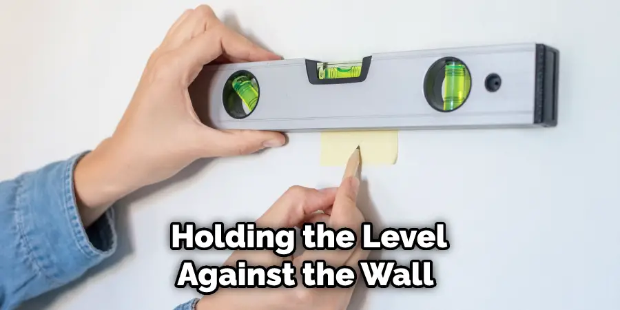  Holding the Level Against the Wall 