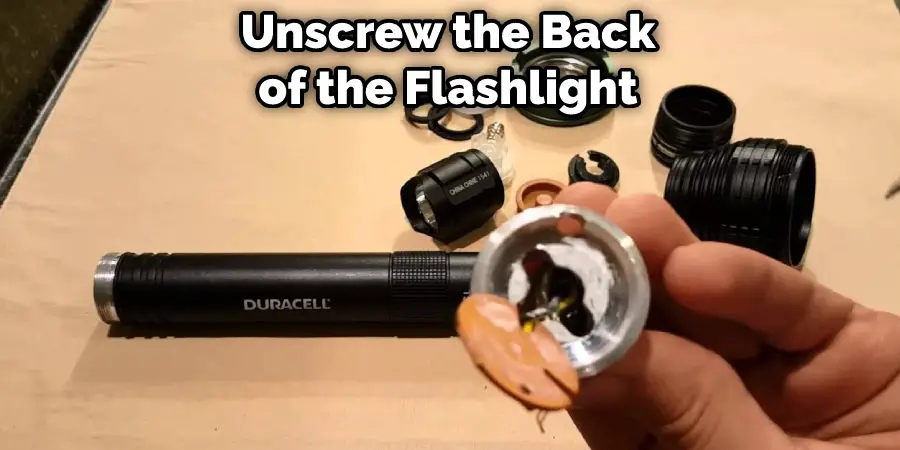 Unscrew the Back of the Flashlight